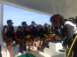 a group of people on a boat taking pictures at Xen Midu Hotel Addu City Maldives in Midu