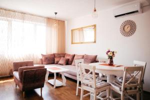 a living room with a couch and a table at Lux Apartment I Prijedor in Prijedor