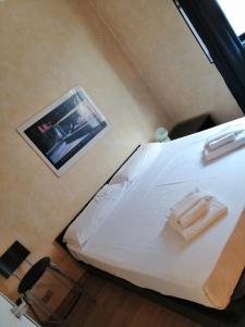 a bedroom with a bed with a picture on the wall at MARCONI TURIN Loft, studio nei pressi di Porta Nuova in Turin