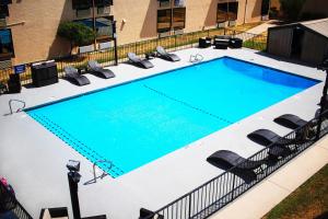 an overhead view of a swimming pool with chairs at Abilene Whitten Inn in Abilene