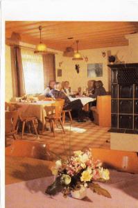 a group of people sitting at tables in a restaurant at Gasthof zum Kirchenwirt in Kirchdorf am Inn