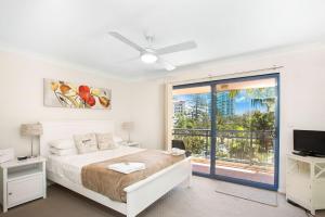 a bedroom with a bed and a television at Bella Mare Coolangatta Beachside Apartments in Gold Coast