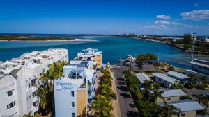 an aerial view of a city and the ocean at Tripcony Quays in Caloundra