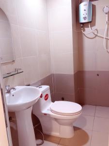 a bathroom with a toilet and a sink at Aurora Hotel in Ho Chi Minh City