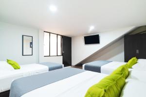 um quarto de hotel com duas camas e uma televisão em Ayenda 1045 Boutique Aeropuerto em Bogotá