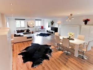 ein Wohnzimmer mit einem weißen Tisch und einem schwarzen Teppich in der Unterkunft Haus Sonnenschein in Bremen