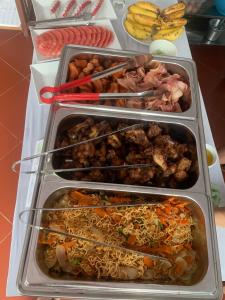 a refrigerator filled with different types of food at Jasmine Vangvieng Hotel in Vang Vieng