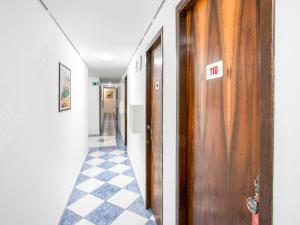 a hallway with a door with a no sign on it at Hotel Golden Vilage Vila Maria in São Paulo