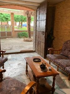 a living room with a table and a couch at CAL GUINEU in Vallfogona de Balaguer