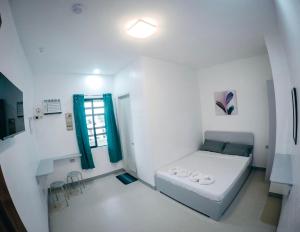 Ένα ή περισσότερα κρεβάτια σε δωμάτιο στο Bulusan Tourist Inn