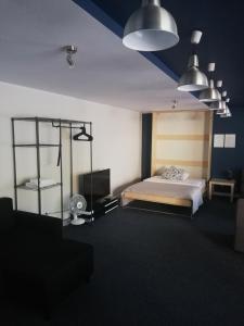 a bedroom with a bed and two pendant lights at Hotel Gold in Poznań
