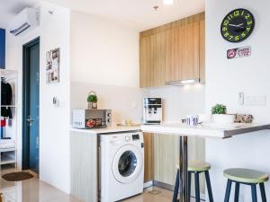 a kitchen with a washer and dryer at Tropicana 218 Macalister Studio with Seaview in George Town