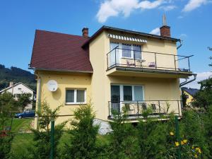 a yellow house with a balcony at Apartmá Andělka in Lipova Lazne