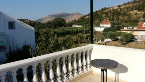 a balcony with a table and a view of a mountain at Natalya in Lixouri