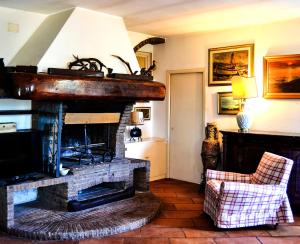- un salon avec une cheminée en briques et une chaise dans l'établissement Casa Lalla, à Livourne