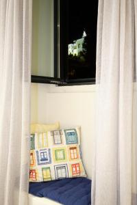 a window with a pillow and a window with curtains at Sintra Bliss A Part in Sintra