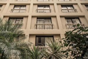 a tall white building with windows and balconies at The Playford Adelaide - MGallery in Adelaide