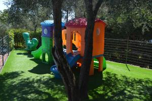 a group of childrens play sets sitting next to a tree at Campeggio Gianna Golfo dei Poeti in Lerici