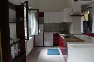 a kitchen with white counters and red cabinets at Un loft solo per i tuoi occhi in Bergamo +9 photos