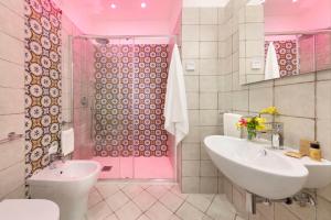 a pink bathroom with a sink and a shower at Delle Rose Suites in Piano di Sorrento