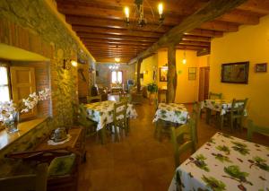 a restaurant with tables and chairs in a room at Posada La Rivera De Escalante in Escalante