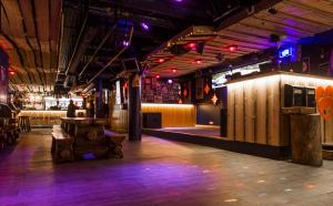 una stanza vuota con un bar con luci viola di Hotel Arctic Zone a Ruka