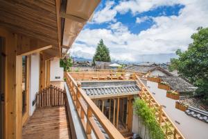 a balcony with a view of a house at Eden Court in Lijiang