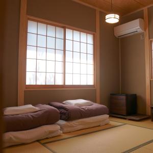 Postel nebo postele na pokoji v ubytování Kinoya Hostel