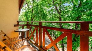 a balcony of a house with a table and trees at Apartamenty EverySky - Nad Łomnicą 1E-2B in Karpacz