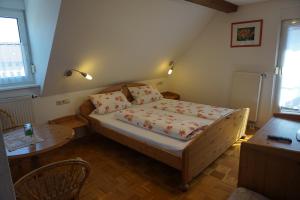 a small bedroom with a bed and a table at Gasthaus Zur Krone in Windelsbach