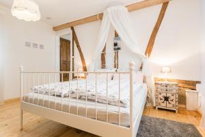 a bedroom with a white bed with a canopy at Gemütliche Fachwerkwohnung in Alfter