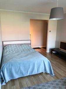 um quarto com uma cama com um cobertor azul em 1-Bedroom apartment in city centre em Paide