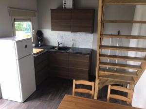 een kleine keuken met een wastafel en een koelkast bij Camping Thalassa Belgische Kust Vakantiehuis in Bredene