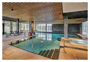 a large swimming pool in a house with a pool at Pałac Łochów in Łochów