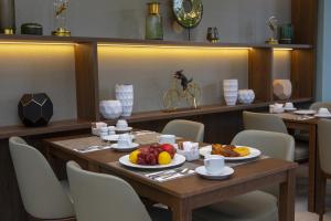 a dining room with a table with fruit on it at Riu Plaza España in Madrid