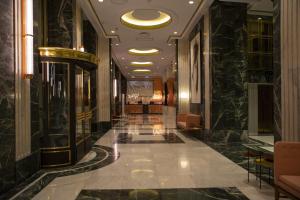 a hallway of a hotel with a lobby with black marble at Riu Plaza España in Madrid