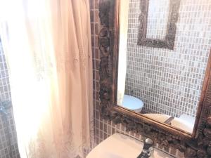 a bathroom with a mirror and a sink at Villa La dame blanche in Skala Potamias +22 photos