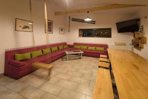 a living room with a red couch and a table at Vila M 36 in Topliţa