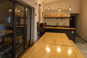 a kitchen with a wooden table in a room at Vila M 36 in Topliţa