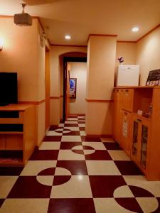 a kitchen with a checkered floor in a room at HOTEL CIMA Ⅱ ( Adult Only ) in Kotohira