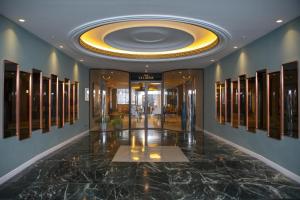 a hallway with a lobby with a large ceiling at Riu Plaza España in Madrid