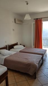 a hotel room with a bed and two lamps at Hotel Orfeas in Delphi