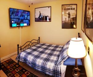 a bedroom with a bed and a flat screen tv at A1 Private Room With 55" Smart TV Near Everything in Orlando