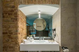 a bathroom with a white sink and a mirror at Artagonist Art Hotel in Vilnius
