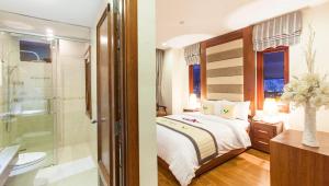 a hotel room with a bed and a shower at Moonlight Hotel & Suites - Highfloor view of the city center and Dragon Bridge in Danang +24 photos
