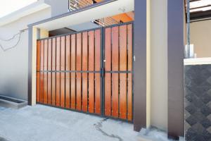 a gate in a building with orange doors at RedDoorz Syariah near Stasiun Tegal in Tegal