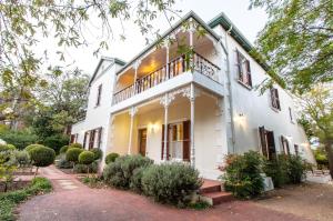 una imagen de una casa blanca con porche en Evergreen Manor and Spa, en Stellenbosch
