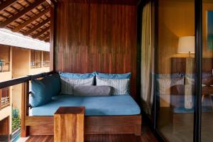 a bed in a room with a wooden wall at Avatar Railay in Railay Beach