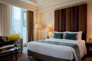 a hotel room with a large bed and a couch at Royal Grace Hotel Optics Valley Wuhan in Wuhan +98 photos