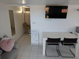 Una sala de estar con una mesa y sillas y un sofá. en 2 person Apartment Ascain, en Ascain